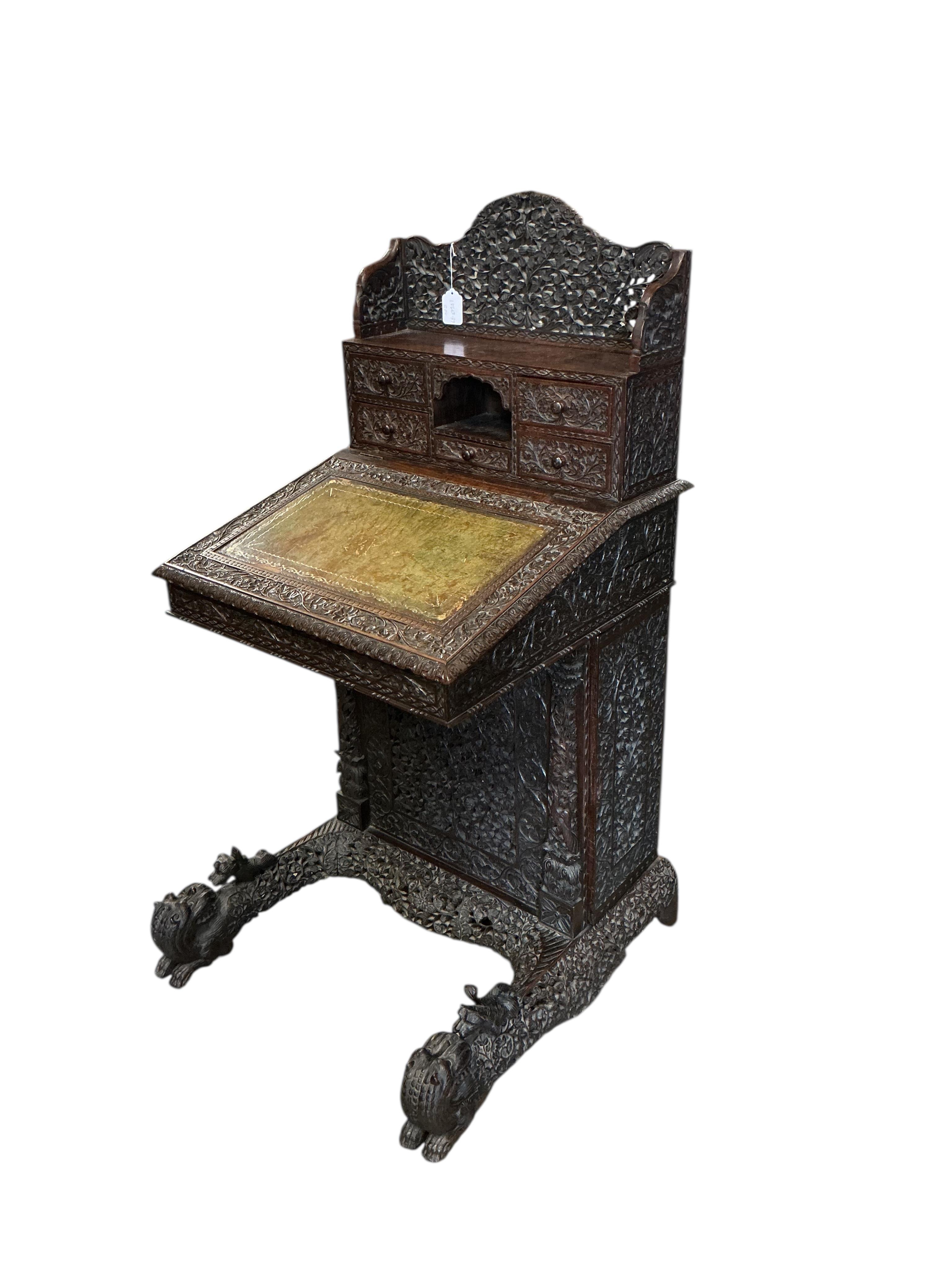 A 19th century Burmese carved hardwood Davenport, width 65cm, depth 67cm, height 122cm
